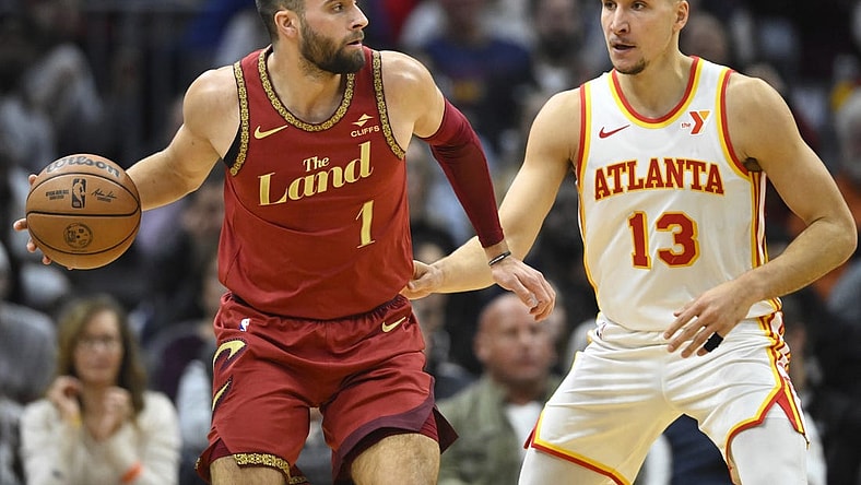 Nov 28, 2023; Cleveland, Ohio, USA; Atlanta Hawks guard Bogdan Bogdanovic (13) defends Cleveland Cavaliers guard Max Strus (1) in the second quarter at Rocket Mortgage FieldHouse. Mandatory Credit: David Richard-USA TODAY Sports