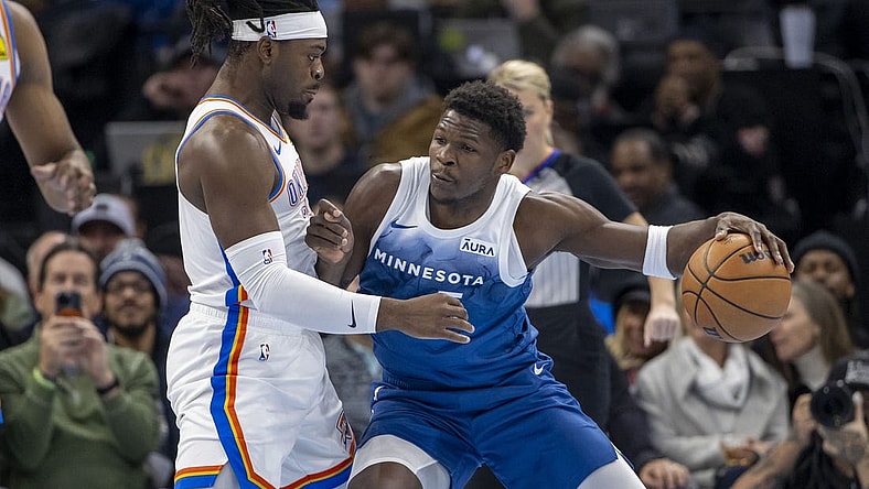 Nov 28, 2023; Minneapolis, Minnesota, USA; Minnesota Timberwolves guard Anthony Edwards (5) backs toward the basket as Oklahoma City Thunder guard Luguentz Dort (5) plays defense in the first half at Target Center. Mandatory Credit: Jesse Johnson-USA TODAY Sports