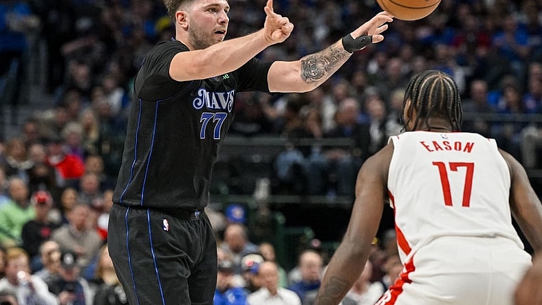 Nov 28, 2023; Dallas, Texas, USA; Dallas Mavericks guard Luka Doncic (77) passes the ball over Houston Rockets forward Tari Eason (17) during the second quarter at the American Airlines Center. Mandatory Credit: Jerome Miron-USA TODAY Sports