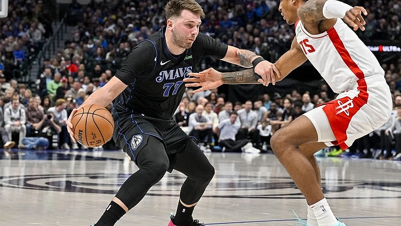 Nov 28, 2023; Dallas, Texas, USA; Dallas Mavericks guard Luka Doncic (77) looks to move the ball past Houston Rockets forward Jabari Smith Jr. (10) during the second quarter at the American Airlines Center. Mandatory Credit: Jerome Miron-USA TODAY Sports