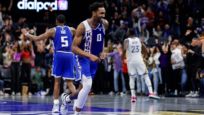 Nov 28, 2023; Sacramento, California, USA; Sacramento Kings guard Malik Monk (0) smiles after scoring a basket during the fourth quarter against the Golden State Warriors at Golden 1 Center. Mandatory Credit: Sergio Estrada-USA TODAY Sports
