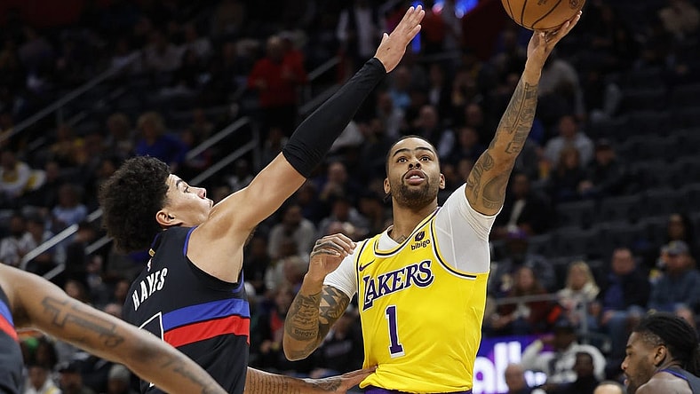 Nov 29, 2023; Detroit, Michigan, USA; Los Angeles Lakers guard D'Angelo Russell (1) shoots on Detroit Pistons guard Killian Hayes (7) in the first half at Little Caesars Arena. Mandatory Credit: Rick Osentoski-USA TODAY Sports