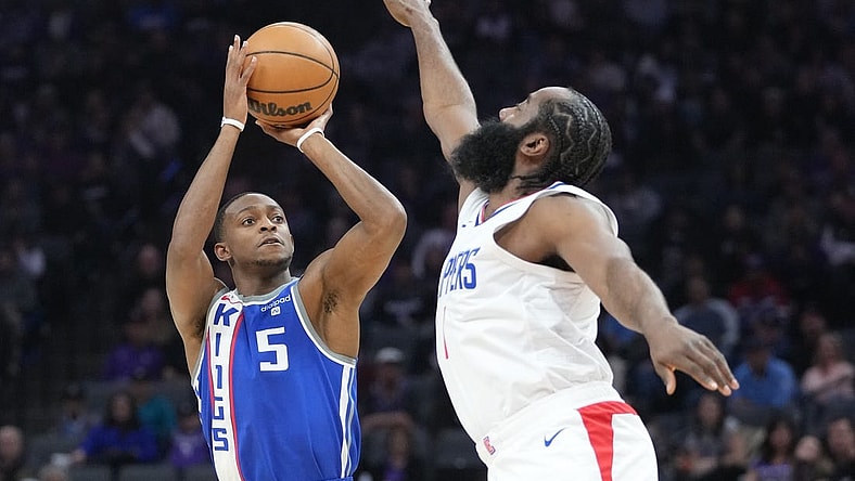 November 29, 2023; Sacramento, California, USA; Sacramento Kings guard De'Aaron Fox (5) shoots the basketball against LA Clippers guard James Harden (1) during the first quarter at Golden 1 Center. Mandatory Credit: Kyle Terada-USA TODAY Sports