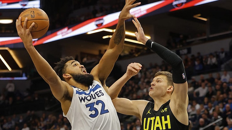 Nov 30, 2023; Minneapolis, Minnesota, USA; Minnesota Timberwolves forward Karl-Anthony Towns (32) shoots against Utah Jazz center Walker Kessler (24) in the first quarter at Target Center. Mandatory Credit: Bruce Kluckhohn-USA TODAY Sports