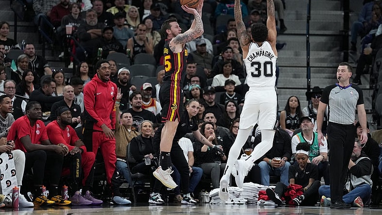 Nov 30, 2023; San Antonio, Texas, USA;  Atlanta Hawks guard Garrison Mathews (25) shoots over San Antonio Spurs forward Julian Champagnie (30) in the first half at the Frost Bank Center. Mandatory Credit: Daniel Dunn-USA TODAY Sports