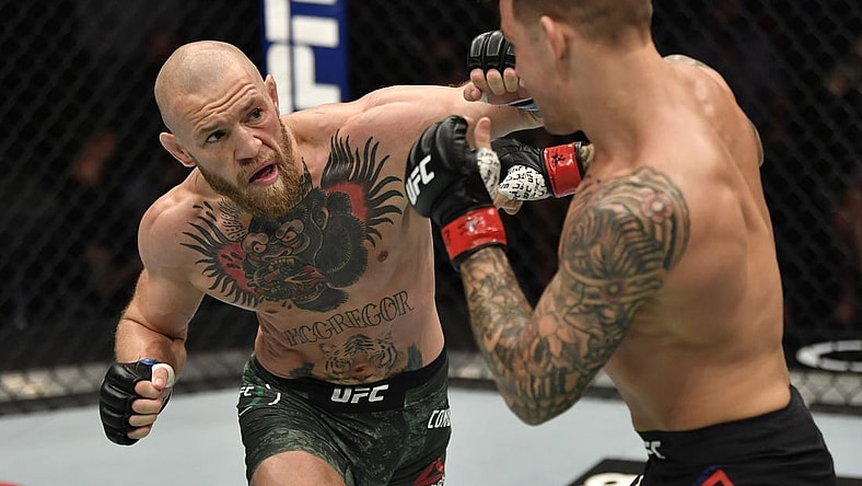 Jan 23, 2021; Abu Dhabi, United Arab Emirates; Conor McGregor of Ireland punches Dustin Poirier in a lightweight fight during the UFC 257 event inside Etihad Arena on UFC Fight Island.  Mandatory Credit: Jeff Bottari/Handout Photo via USA TODAY Sports