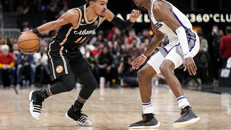 Nov 23, 2022; Atlanta, Georgia, USA; Atlanta Hawks guard Trae Young (11) dribbles against Sacramento Kings guard De'Aaron Fox (5) during the second half at State Farm Arena. Mandatory Credit: Dale Zanine-USA TODAY Sports