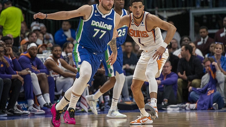 Dec 5, 2022; Dallas, Texas, USA; Phoenix Suns guard Devin Booker (1) and Dallas Mavericks guard Luka Doncic (77) in action during the game between the Dallas Mavericks and the Phoenix Suns at American Airlines Center. Mandatory Credit: Jerome Miron-USA TODAY Sports