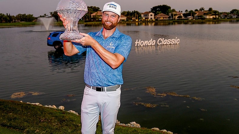 Chris Kirk holds the championship trophy after his playoff victory over Eric Cole in the final round of the Honda Classic at PGA National Resort & Spa on Sunday, February 26, 2023, in Palm Beach Gardens, FL.