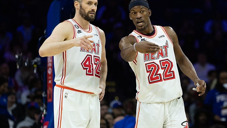Feb 27, 2023; Philadelphia, Pennsylvania, USA; Miami Heat forward Jimmy Butler (22) talks with forward Kevin Love (42) during a break in action in the second quarter against the Philadelphia 76ers at Wells Fargo Center. Mandatory Credit: Bill Streicher-USA TODAY Sports