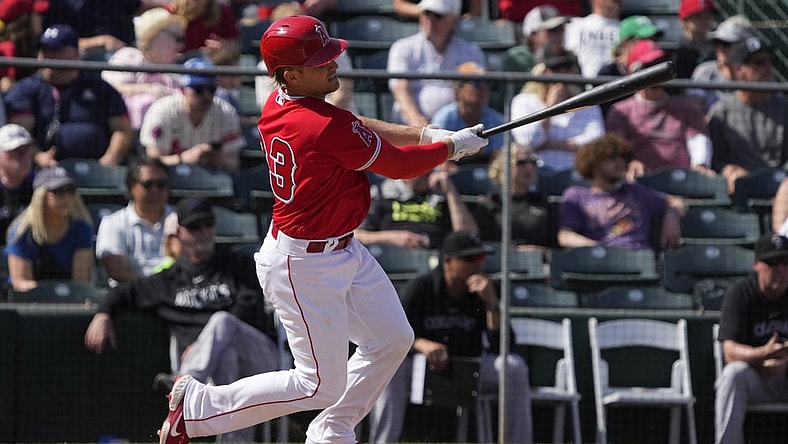 Mar 8, 2023; Tempe, Arizona, USA; Los Angeles Angels catcher Max Stassi (33) hits a single against the Colorado Rockies in the fourth inning at Tempe Diablo Stadium. Mandatory Credit: Rick Scuteri-USA TODAY Sports