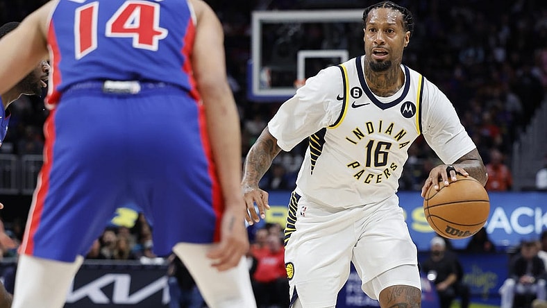 Mar 11, 2023; Detroit, Michigan, USA;  Indiana Pacers forward James Johnson (16) dribbles the ball against Detroit Pistons guard R.J. Hampton (14) in the second half at Little Caesars Arena. Mandatory Credit: Rick Osentoski-USA TODAY Sports