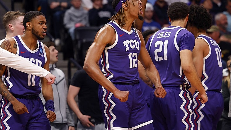 Mar 19, 2023; Denver, CO, USA; TCU Horned Frogs forward Xavier Cork (12) and guard Rondel Walker (11) and forward JaKobe Coles (21) celebrate on the bench in the first half against the Gonzaga Bulldogs at Ball Arena. Mandatory Credit: Michael Ciaglo-USA TODAY Sports