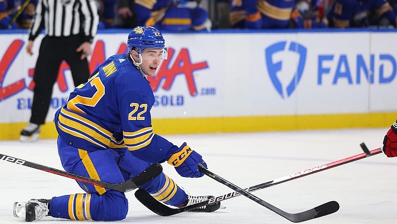 Apr 8, 2023; Buffalo, New York, USA;  Buffalo Sabres right wing Jack Quinn (22) makes a pass as he falls during the second period against the Carolina Hurricanes at KeyBank Center. Mandatory Credit: Timothy T. Ludwig-USA TODAY Sports