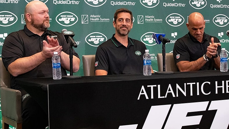 Apr 26, 2023; Florham Park, NJ, USA; New York Jets quarterback Aaron Rodgers (8) (center) is introduced during the introductory press conference alongside general manager Joe Douglas (left) and head coach Robert Saleh (right) at Atlantic Health Jets Training Center. Mandatory Credit: Tom Horak-USA TODAY Sports