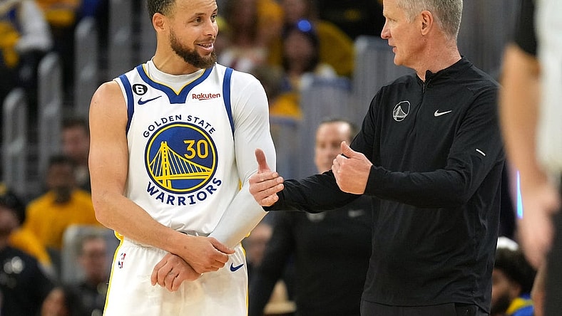 Apr 23, 2023; San Francisco, California, USA; Golden State Warriors guard Stephen Curry (30) talks with head coach Steve Kerr during the third quarter of game four of the 2023 NBA playoffs against the Sacramento Kings at Chase Center. Mandatory Credit: Darren Yamashita-USA TODAY Sports