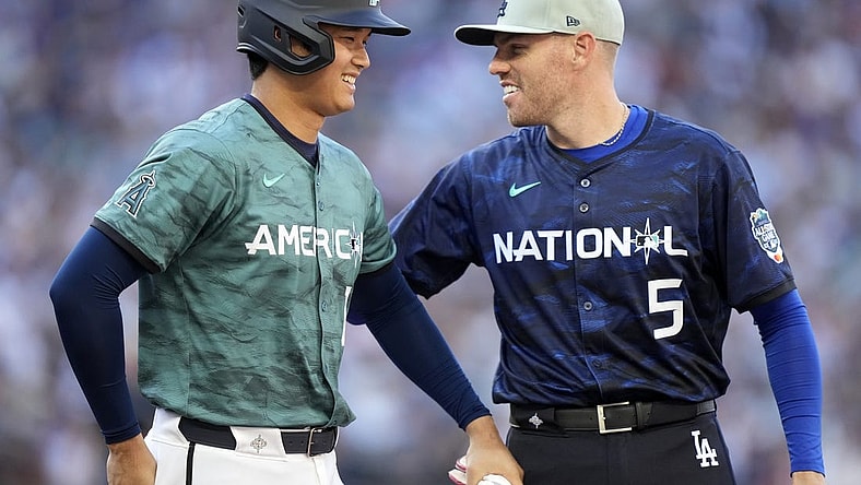 Jul 11, 2023; Seattle, Washington, USA; American League designated hitter/pitcher  Shohei Ohtani  of the Los Angeles Angels of Anaheim (17) reacts with National League first baseman  Freddie Freeman  of the Los Angeles Dodgers (5) during the fifth inning at T-Mobile Park. Mandatory Credit: Stephen Brashear-USA TODAY Sports