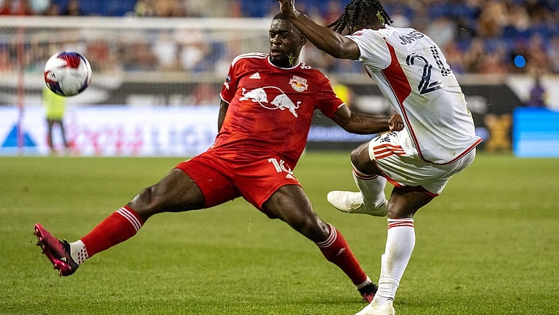 Jul 22, 2023; Harrison, NJ, USA; New York Red Bulls midfielder Dru Yearwood (16) blocks a pass by New England Revolution forward DeJuan Jones (24) during the second half at Red Bull Arena. Mandatory Credit: Mark Smith-USA TODAY Sports