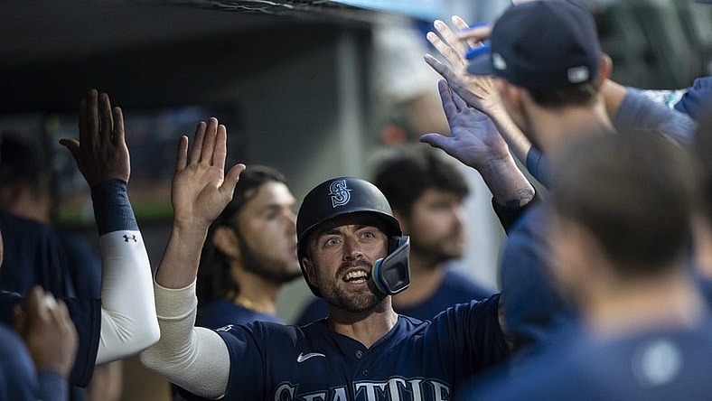 Aug 8, 2023; Seattle, Washington, USA; Seattle Mariners catcher Tom Murphy (2) celebrates in the dugout after scoring a run during the sixth inning against the San Diego Padres at T-Mobile Park. Mandatory Credit: Stephen Brashear-USA TODAY Sports