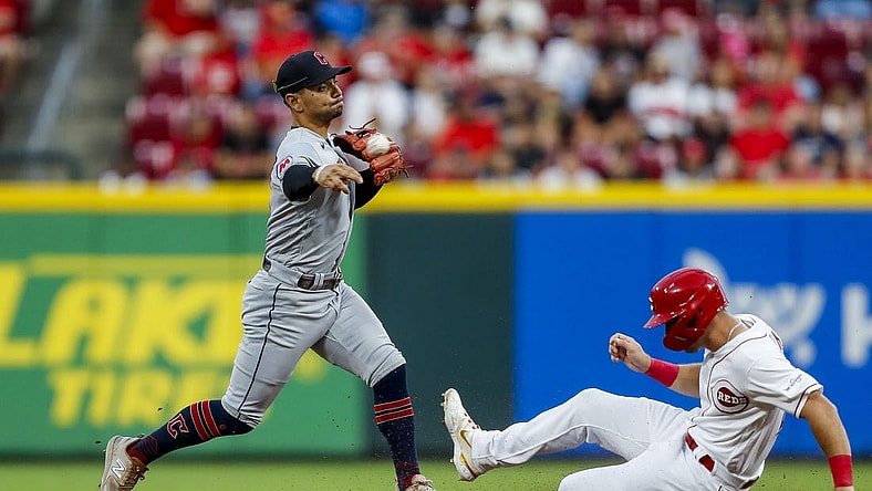 Aug 15, 2023; Cincinnati, Ohio, USA; Cleveland Guardians second baseman Andres Gimenez (0) forces out Cincinnati Reds centerfielder TJ Hopkins at second and throws to first to get Kevin Newman (not pictured) out to complete the double play in the fifth inning at Great American Ball Park. Mandatory Credit: Katie Stratman-USA TODAY Sports