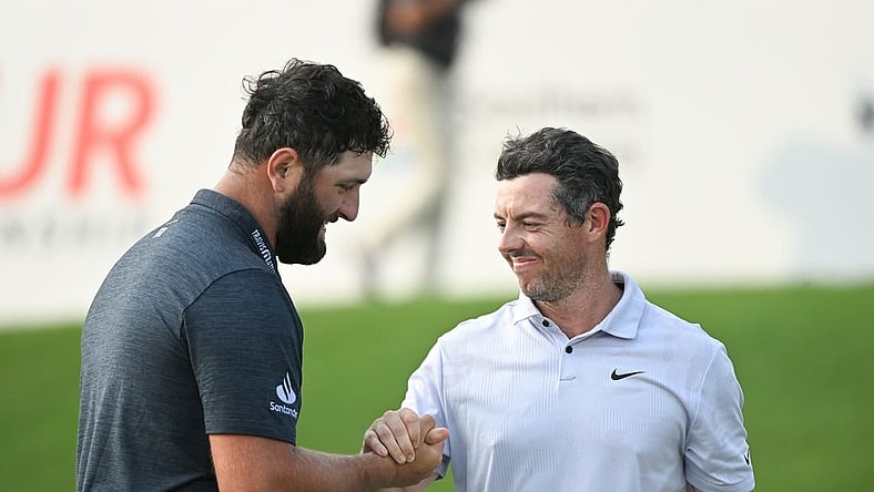 Aug 24, 2023; Atlanta, Georgia, USA; Jon Rahm shakes hands with Rory McIlroy on the 18th green during the first round of the TOUR Championship golf tournament at East Lake Golf Club. Mandatory Credit: Adam Hagy-USA TODAY Sports