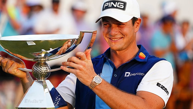 Aug 27, 2023; Atlanta, Georgia, USA; Viktor Hovland celebrate with the FedEx trophy after winning the TOUR Championship golf tournament at East Lake Golf Club. Mandatory Credit: John David Mercer-USA TODAY Sports
