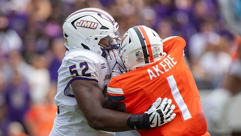 September 9, 22023 in Charlottesville, Virginia; James Madison Dukes offensive lineman Tyshawn Wyatt (52) blocks Virginia Cavaliers defensive end Paul Akere (1) during the first half of the game at Scott Stadium.  Mandatory Credit: Hannah Pajewski-USA TODAY Sports