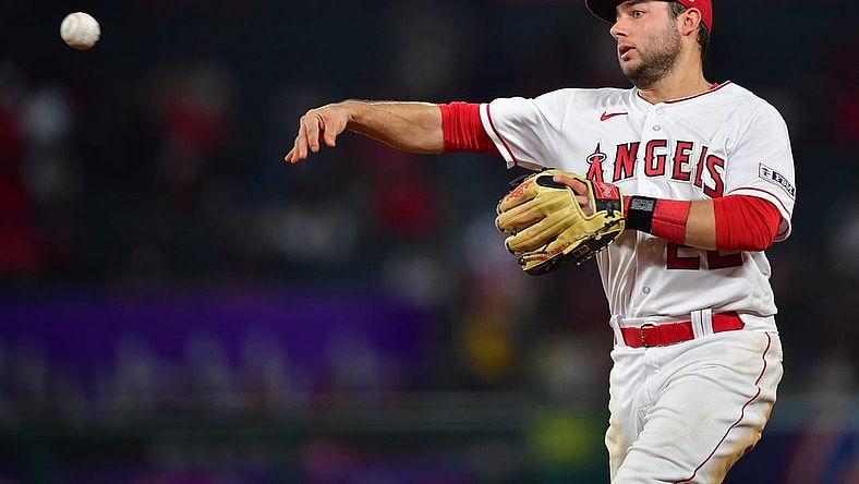 Sep 26, 2023; Anaheim, California, USA; Los Angeles Angels second baseman David Fletcher (22) throws to first for the out against Texas Rangers shortstop Josh Smith (47) during the seventh inning at Angel Stadium. Mandatory Credit: Gary A. Vasquez-USA TODAY Sports