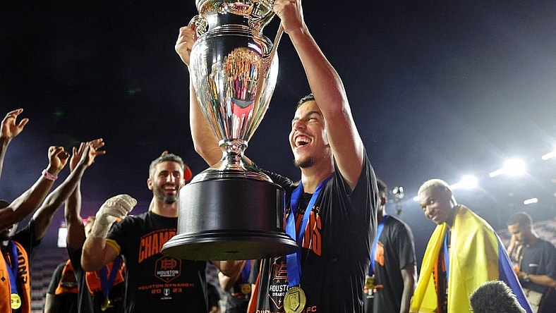 Sep 27, 2023; Fort Lauderdale, FL, USA; Houston Dynamo midfielder Amine Bassi (8) holds up the trophy after winning the Lamar Hunt U.S. Open Cup Final against Inter Miami CF at DRV PNK Stadium. Mandatory Credit: Nathan Ray Seebeck-USA TODAY Sports