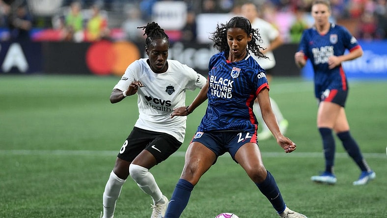 Oct 6, 2023; Seattle, Washington, USA; Washington Spirit forward Ouleymata Sarr (8) and OL Reign defender Ryanne Brown (22) battle for the ball during the second half at Lumen Field. Mandatory Credit: Steven Bisig-USA TODAY Sports