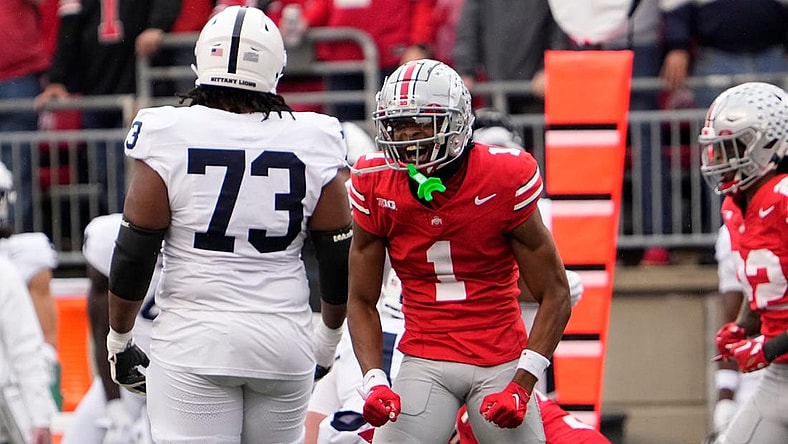 Oct 21, 2023; Columbus, Ohio, USA; Ohio State Buckeyes cornerback Davison Igbinosun (1) celebrates in front of Penn State Nittany Lions offensive lineman Caedan Wallace (73) during the NCAA football game at Ohio Stadium.