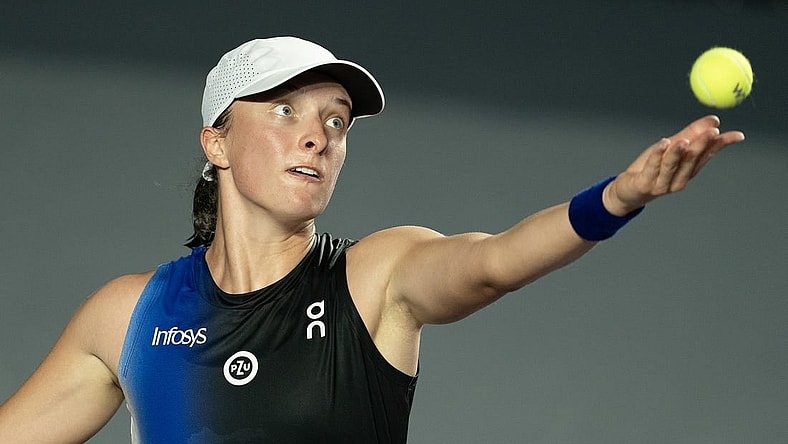 Oct 30, 2023; Cancun, Mexico;  Iga Swiatek (POL) tosses the ball to serve during her match against Marketa Vondrousova (CZE) on day two of the GNP Saguaros WTA Finals Cancun. Mandatory Credit: Susan Mullane-USA TODAY Sports