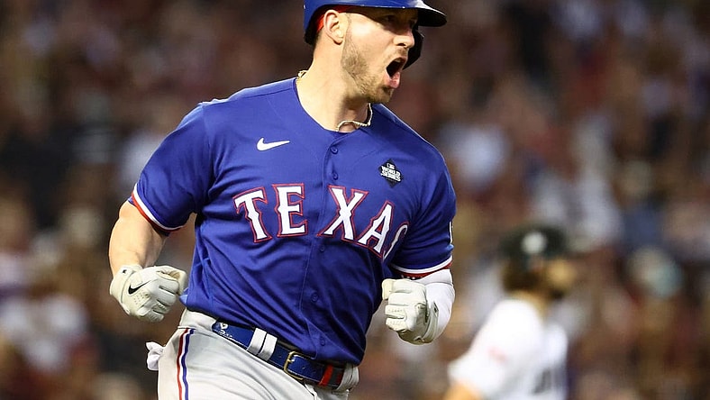 Nov 1, 2023; Phoenix, Arizona, USA; Texas Rangers catcher Mitch Garver (18) reacts after hitting a RBI single against the Arizona Diamondbacks during the sixth inning in game five of the 2023 World Series at Chase Field. Mandatory Credit: Mark J. Rebilas-USA TODAY Sports