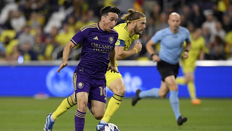 Nov 7, 2023; Nashville, Tennessee, USA; Orlando City midfielder Mauricio Pereyra (10) controls the ball against the Nashville SC in the first half at Geodis Park. Mandatory Credit: Steve Roberts-USA TODAY Sports