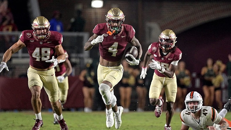 Nov 11, 2023; Tallahassee, Florida, USA; Florida State Seminoles wide receiver Keon Coleman (4) returns a punt in the second half against the Miami Hurricanes at Doak S. Campbell Stadium. Mandatory Credit: Melina Myers-USA TODAY Sports
