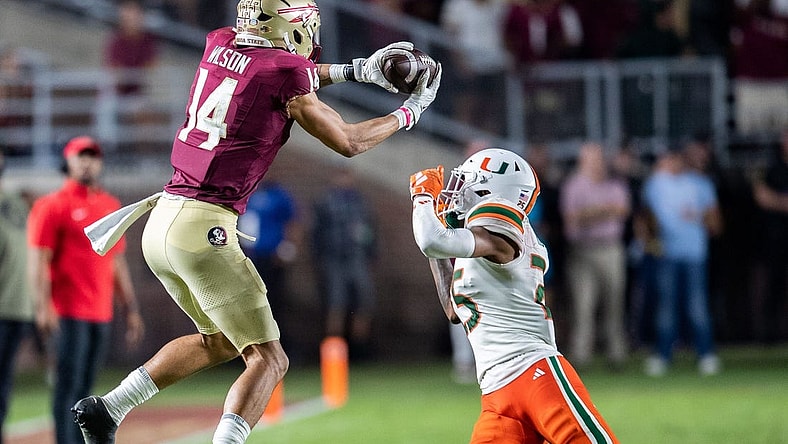 Florida State Seminoles wide receiver Johnny Wilson (14) catches a pass from Florida State Seminoles quarterback Jordan Travis (13). The Florida State Seminoles defeated the Miami Hurricanes 27-20 on Saturday, Nov. 11, 2023.