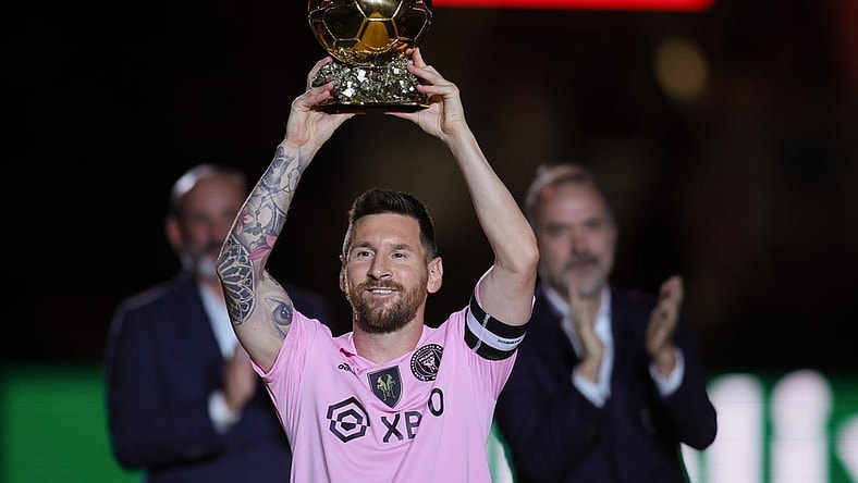 Nov 10, 2023; Lauderdale, FL, USA; Inter Miami forward Lionel Messi (10) poses with the Ballon d'Or trophy before the game against New York City at DRV PNK Stadium. Mandatory Credit: Sam Navarro-USA TODAY Sports