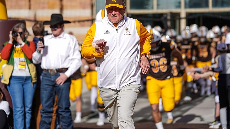 Nov 18, 2023; Laramie, Wyoming, USA; Wyoming Cowboys head coach Craig Bohl leads his team onto the field before the game against the Hawaii Rainbow Warriors at Jonah Field at War Memorial Stadium. Mandatory Credit: Troy Babbitt-USA TODAY Sports