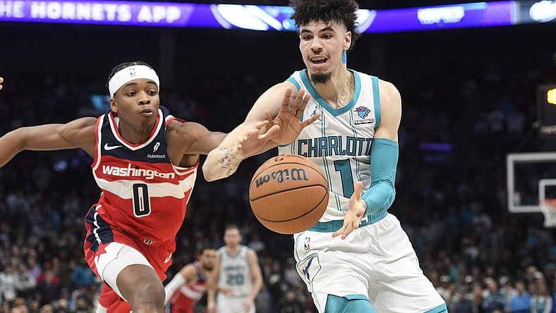 Nov 22, 2023; Charlotte, North Carolina, USA; Charlotte Hornets guard LaMelo Ball (1) catches a pass as Washington Wizards guard Bilal Coulibaly (0) attempts to steal during the second half at the Spectrum Center. Mandatory Credit: Sam Sharpe-USA TODAY Sports