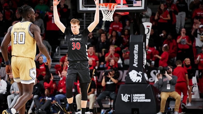 Cincinnati Bearcats forward Viktor Lakhin (30) encourages the crowd after a made 3-point basket in the second half during an NCAA college basketball game between Georgia Tech Yellow Jackets and the Cincinnati Bearcats, Wednesday, Nov. 22, 2023, at Fifth Third Arena in Cincinnati.