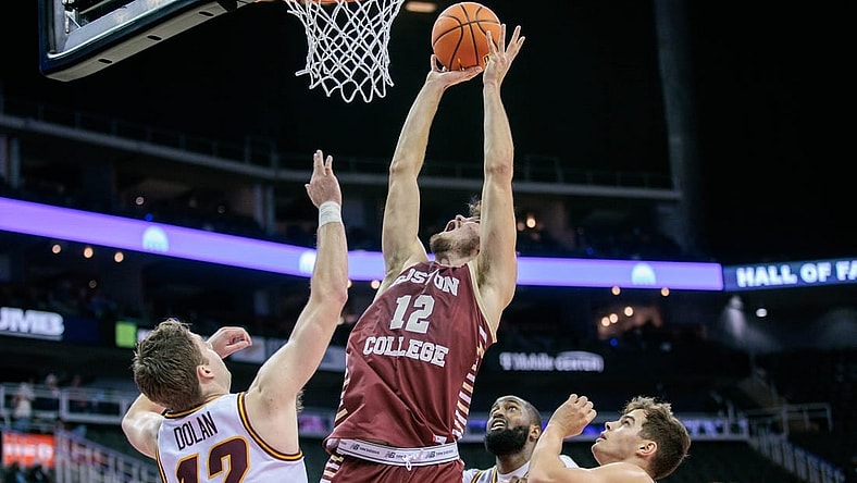 Nov 23, 2023; Kansas City, Missouri, USA; Boston College Eagles forward Quinten Post (12) goes after a rebound during the first half against the Loyola (Il) Ramblers at T-Mobile Center. Mandatory Credit: William Purnell-USA TODAY Sports
