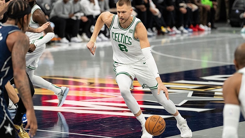 Nov 24, 2023; Orlando, Florida, USA; Boston Celtics forward Kristaps Porzingis (8) dribbles the ball against the Orlando Magic in the first quarter at Amway Center. Mandatory Credit: Jeremy Reper-USA TODAY Sports