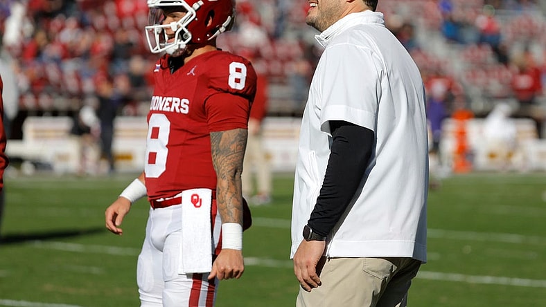 Oklahoma offensive coordinator Jeff Lebby talks with Oklahoma Sooners quarterback Dillon Gabriel (8) before a college football game between the University of Oklahoma Sooners (OU) and the TCU Horned Frogs at Gaylord Family-Oklahoma Memorial Stadium in Norman, Okla., Friday, Nov. 24, 2023. Oklahoma won 69-45.
