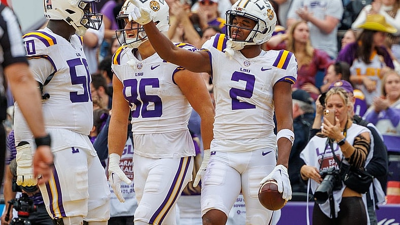 Nov 25, 2023; Baton Rouge, Louisiana, USA;  LSU Tigers wide receiver Kyren Lacy (2) points to quarterback Jayden Daniels (5) after scoring a touchdown against the Texas A&M Aggies during the second half at Tiger Stadium. Mandatory Credit: Stephen Lew-USA TODAY Sports