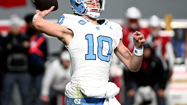 Nov 25, 2023; Raleigh, North Carolina, USA; North Carolina Tar Heels quarterback Drake Maye (10) throws a pass against the North Carolina State Wolfpack during the first half at Carter-Finley Stadium. Mandatory Credit: Rob Kinnan-USA TODAY Sports