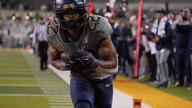 Nov 25, 2023; Waco, Texas, USA; West Virginia Mountaineers running back Jahiem White (22) makes the game winning 29-yard touchdown catch against the Baylor Bears during the second half at McLane Stadium. Mandatory Credit: Raymond Carlin III-USA TODAY Sports