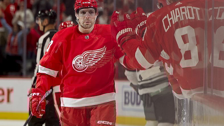 Nov 26, 2023; Detroit, Michigan, USA; Detroit Red Wings left wing David Perron (57) receives congratulations from teammates after scoring in the third period against the Minnesota Wild at Little Caesars Arena. Mandatory Credit: Rick Osentoski-USA TODAY Sports