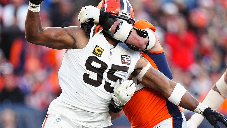 Nov 26, 2023; Denver, Colorado, USA; Denver Broncos offensive tackle Garett Bolles (72) holds Cleveland Browns defensive end Myles Garrett (95) in the second quarter at Empower Field at Mile High. Mandatory Credit: Ron Chenoy-USA TODAY Sports