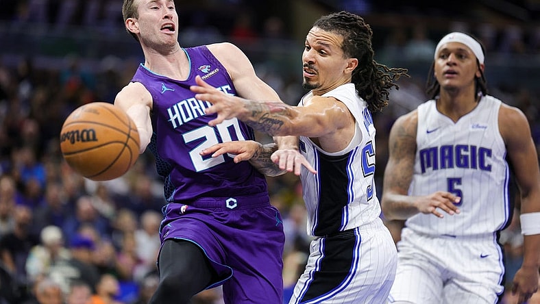 Nov 26, 2023; Orlando, Florida, USA;  Charlotte Hornets forward Gordon Hayward (20) passes the ball past Orlando Magic guard Cole Anthony (50) in the fourth quarter at Amway Center. Mandatory Credit: Nathan Ray Seebeck-USA TODAY Sports