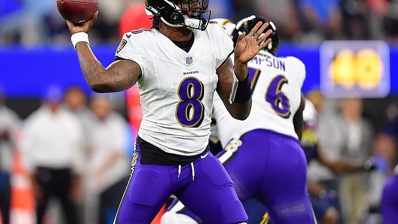 Nov 26, 2023; Inglewood, California, USA; Baltimore Ravens quarterback Lamar Jackson (8) throws against the Los Angeles Chargers during the first half at SoFi Stadium. Mandatory Credit: Gary A. Vasquez-USA TODAY Sports